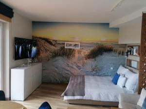 a bedroom with a beach mural on the wall at Apartament Słoneczna Przystań Sobieszewo in Gdańsk