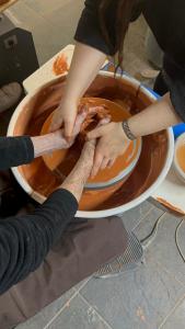 a person mixing ingredients in a bowl of sauce at Cerdeira - Home for Creativity in Lousã