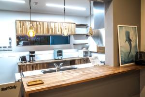 a kitchen with a sink and a counter at Hichu House ハイチューハウス in Nago