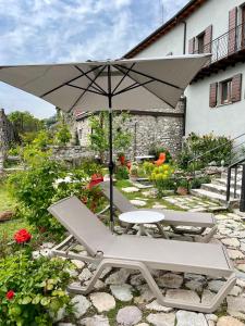 a chair and an umbrella in a garden at Villa del Lis in Gargnano