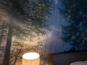 a room with a wall with trees and a lamp at Hotel Neda Galichnik in Galičnik
