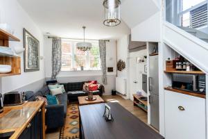 a small living room with a couch and a table at 4 The Old Schoolhouse: Parking, hot tub, garden, air con in Whitstable