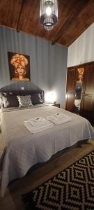 a bedroom with a large bed with a chandelier at Luxury Apartment with balcony in Mytilene