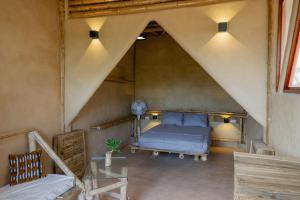 a bedroom with a bed in a room with an attic at Bambú Corner - Casa Consciente in Brisas de Zicatela