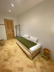 a bedroom with a bed and a wooden floor at Doñana Suite Casa-Hotel in El Rocío