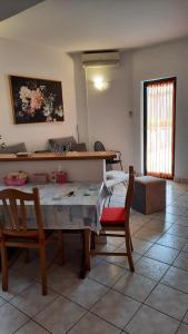 a living room with a table and two chairs at Apartment Aida in Medulin