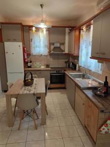 a kitchen with a table and a table and a kitchen with a tableablish at Dream House in Agria