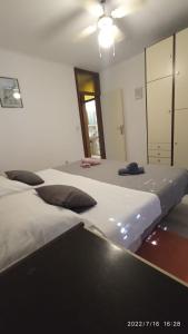1 dormitorio con 2 camas y espejo en Apartman Terazza en Selca