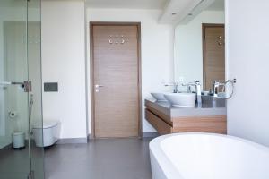 a bathroom with two sinks and a toilet and a shower at Nasma Luxury Stays - City Walk Building 5 in Dubai