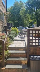 a set of stairs leading to a patio with a table at Peaceful cottage retreat in the Peak District in Wirksworth
