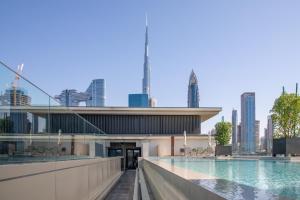 a swimming pool with a city skyline in the background at Nasma Luxury Stays - City Walk Building 5 in Dubai