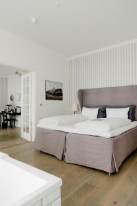 a large white bedroom with a large bed in it at Marienlyst Strandhotel in Helsingør
