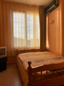 a bedroom with a bed with a large window at Hostel Shabla in Shabla +5 photos