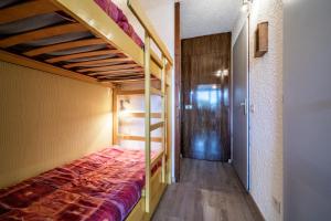 a bedroom with two bunk beds and a hallway at Les Pralyssimes in Taninges