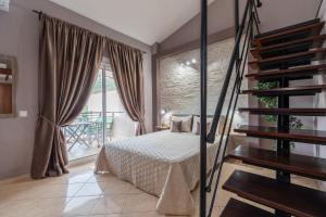 a bedroom with a bed and a balcony at Studios Diogenis in Porto Koufo