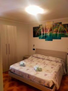 a bedroom with a bed with two shoes on it at Locanda Da Tullio in Capovalle