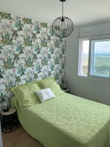 A bed or beds in a room at Delta Muga, Piso muy cerca de la playa