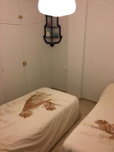 A bed or beds in a room at Delta Muga, Piso muy cerca de la playa