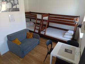 a living room with two bunk beds and a couch at Blues Rooms in Gdynia