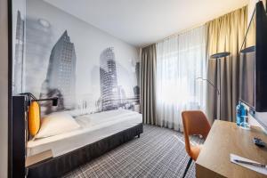 a hotel room with a bed and a desk at Hotel Lützow in Berlin