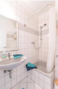 a white bathroom with a shower and a sink at Wuppertal-Ronsdorf Ferienwohnung Appartement für 1-2 in Erbschlö