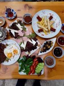 a wooden table with plates of food on it at BAT Apart Otel in Antalya