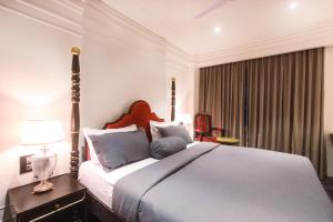a bedroom with a large bed and a window at The Saga Hotel in New Delhi