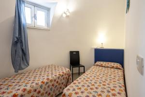 a bedroom with two beds and a window at 3 Sirene Sciacca Fronte Mare in Sciacca