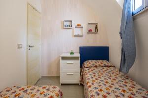 a small bedroom with a bed and a dresser at 3 Sirene Sciacca Fronte Mare in Sciacca