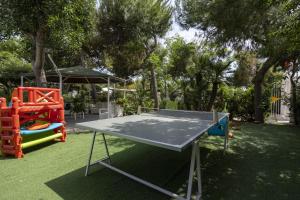 a ping pong table in a yard with a playground at 3 Sirene Sciacca Fronte Mare in Sciacca