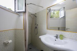 a bathroom with a sink and a mirror at 3 Sirene Sciacca Fronte Mare in Sciacca