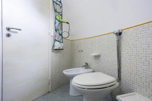 a bathroom with a white toilet and a shower at 3 Sirene Sciacca Fronte Mare in Sciacca +32 photos