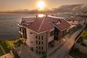 an aerial view of a building with the ocean at DOLPHIN BAY BOUTIQUE COMPLEX Sozopol in Sozopol