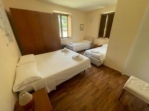En eller flere senger på et rom på Hotel Villa Cerelis