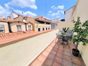 a balcony with a table and chairs on a building at MOLINA - LA LATINA in Madrid