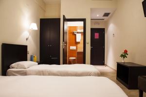 Postel nebo postele na pokoji v ubytování Hotel Meteoritis