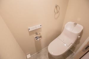 - une salle de bains avec des toilettes blanches dans une cabine dans l'établissement Your best choice for travel in Yoyogi EoY6, à Tokyo