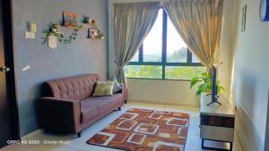 a living room with a couch and a large window at TOP Muzaffar Homestay in Ayer Keroh