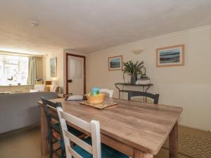 uma sala de jantar com uma mesa de madeira e cadeiras em Lavender Cottage em Lyme Regis