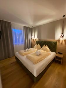 a bedroom with a bed with white sheets and a window at Ferienhaus Petra in Sankt Kanzian