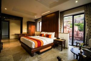 a bedroom with a large bed and a balcony at Marugarh Resort and Spa in Jodhpur +201 photos