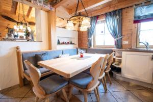 a dining room with a wooden table and chairs at Ferienhaus Königsleiten 175 in Königsleiten