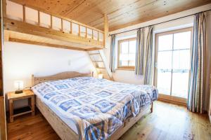 a bedroom with a bed in a room with wooden ceilings at Ferienhaus Königsleiten 175 in Königsleiten