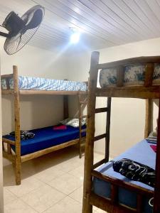 two bunk beds in a room with a hat on the ceiling at Casa top aeroporto in Macaé