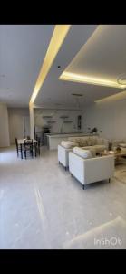 a living room with couches and a table in a room at شاليهات أبيات الفندقية in Al Baha