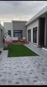 a house with a yard with a green lawn at شاليهات أبيات الفندقية in Al Baha