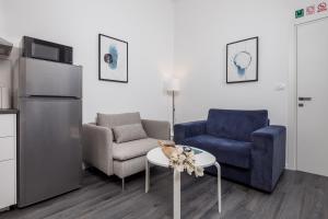 a living room with a couch and a chair and a table at Apartment with balcony Nest In 2 in Rijeka