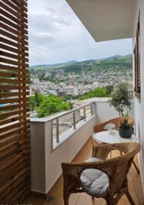 a balcony with a table and chairs and a view at NOVI's Luxury Apartment 2 in Gjirokastër