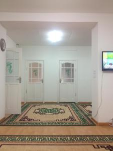 a room with white walls and a rug on the floor at Sunpath Mongolia Tour & Hostel in Ulaanbaatar