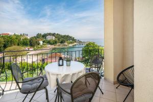 a table on a balcony with a view of the water at Apartment Jelka 2 in Krk